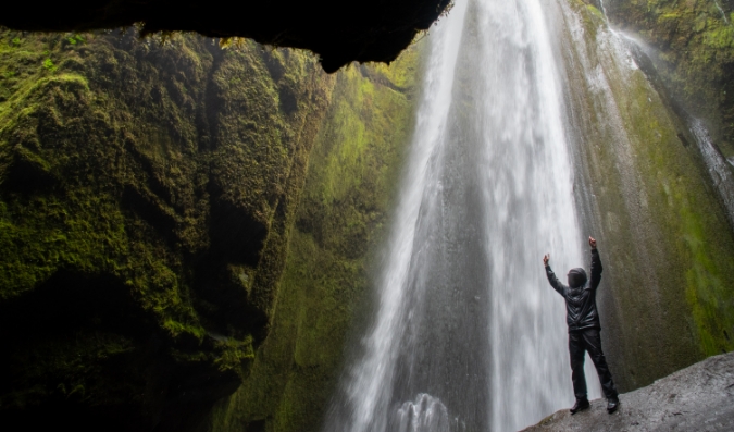 student-arms-stretched-waterfall-iceland