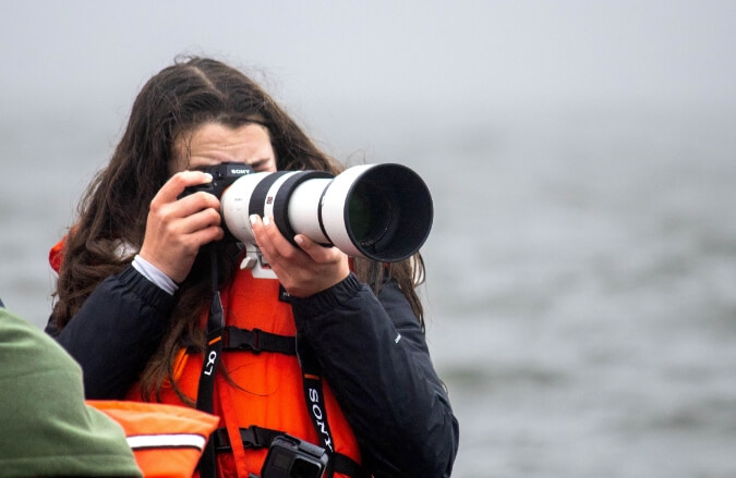 student-taking-photo-on-boat-canada