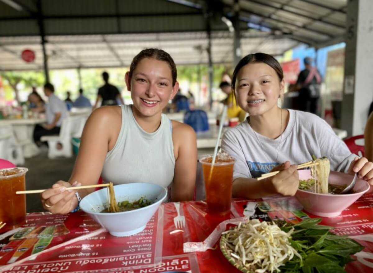 two-students-eating-noodles-thailand